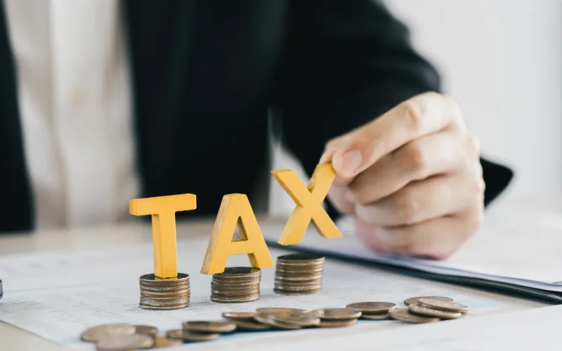 Businessman's hands calculating numbers at a calculator.Tax deduction planning concept.